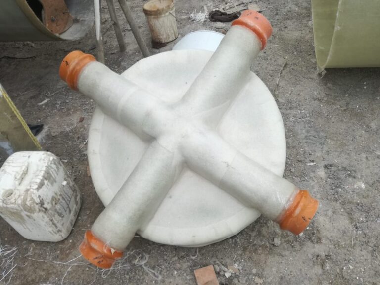 Pipe inlets laminated into a manhole base